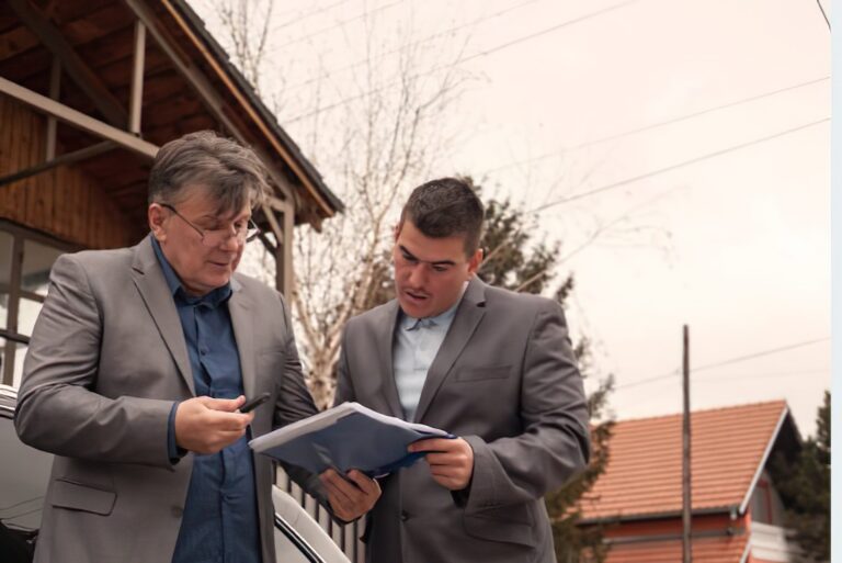 Homeowner discussing fire damage restoration costs with an insurance adjuster