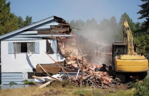 Demolition crew tearing down a building with heavy machinery