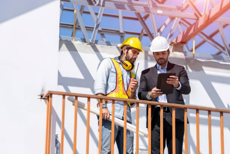 Contractor consulting with insurance agent at construction site