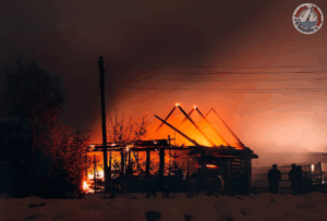 Residential property with severe fire damage showing burnt walls and debris