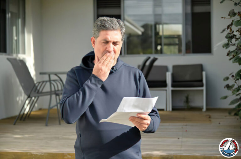 Homeowner reviewing denied mold remediation insurance claim letter