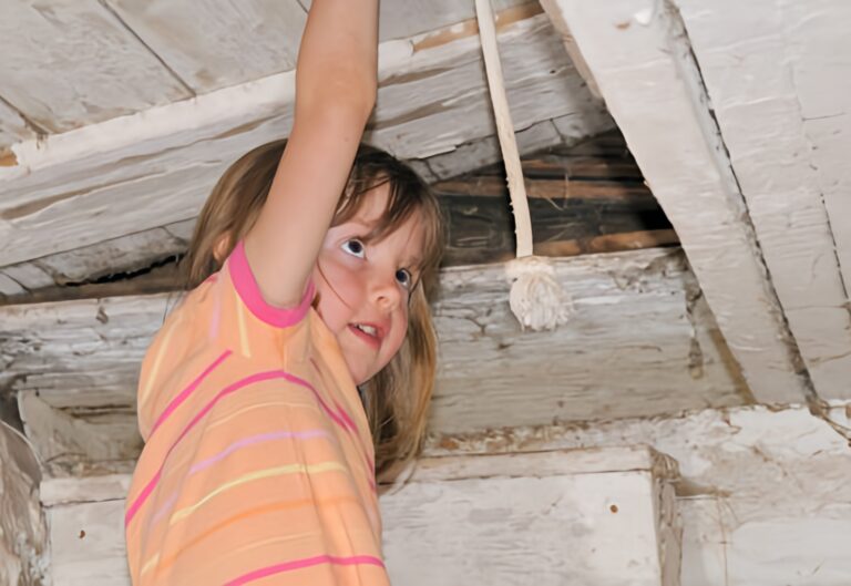 Child playing near peeling paint in an older home at risk for lead exposure