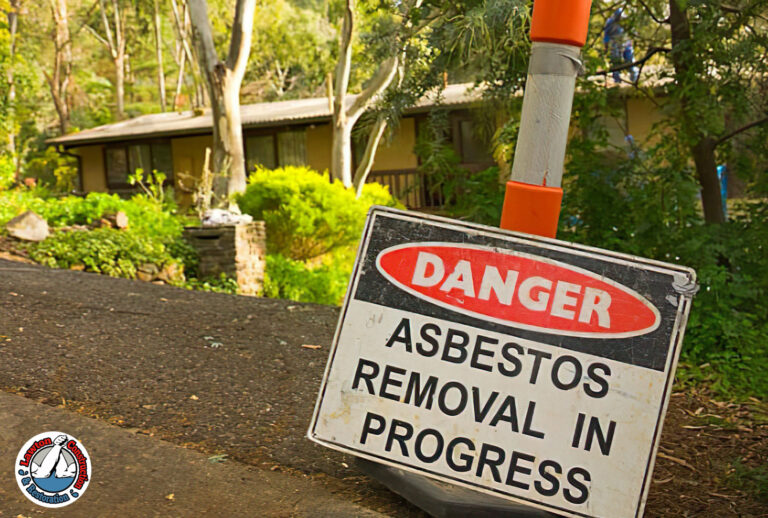 Asbestos removal crew sealing a hazardous work area