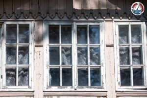 Lead-based paint peeling on an old window frame