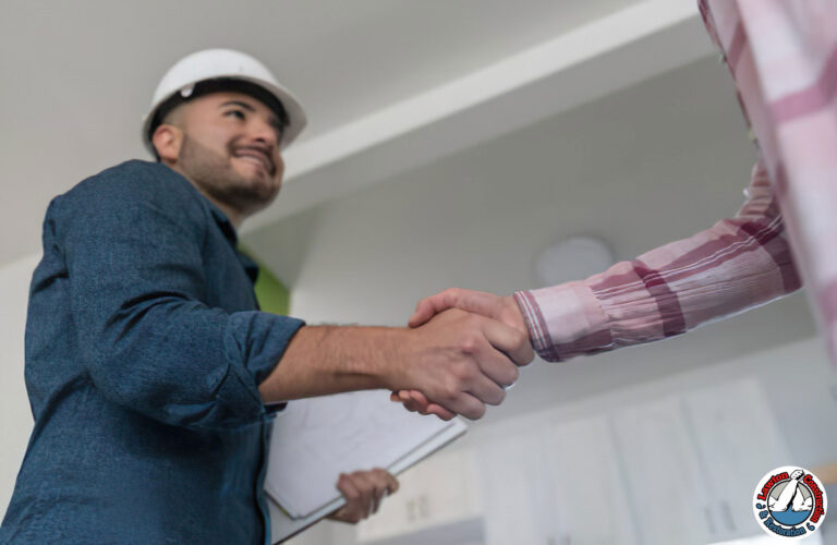 Homeowner shaking hands with a certified lead removal contractor after successful abatement